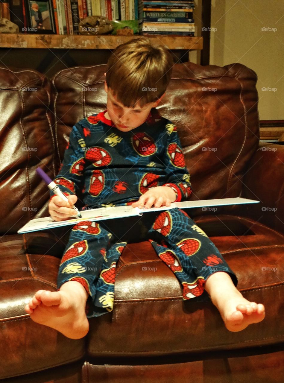 Young Boy Learning To Read And Write
