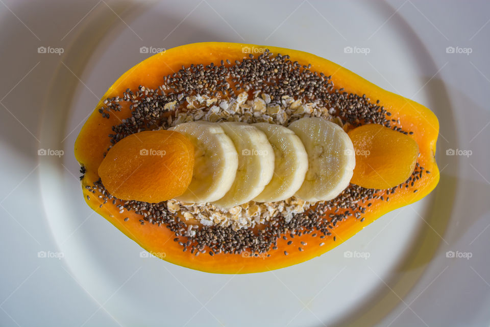 Healthy breakfast with papaya, banana and apricot