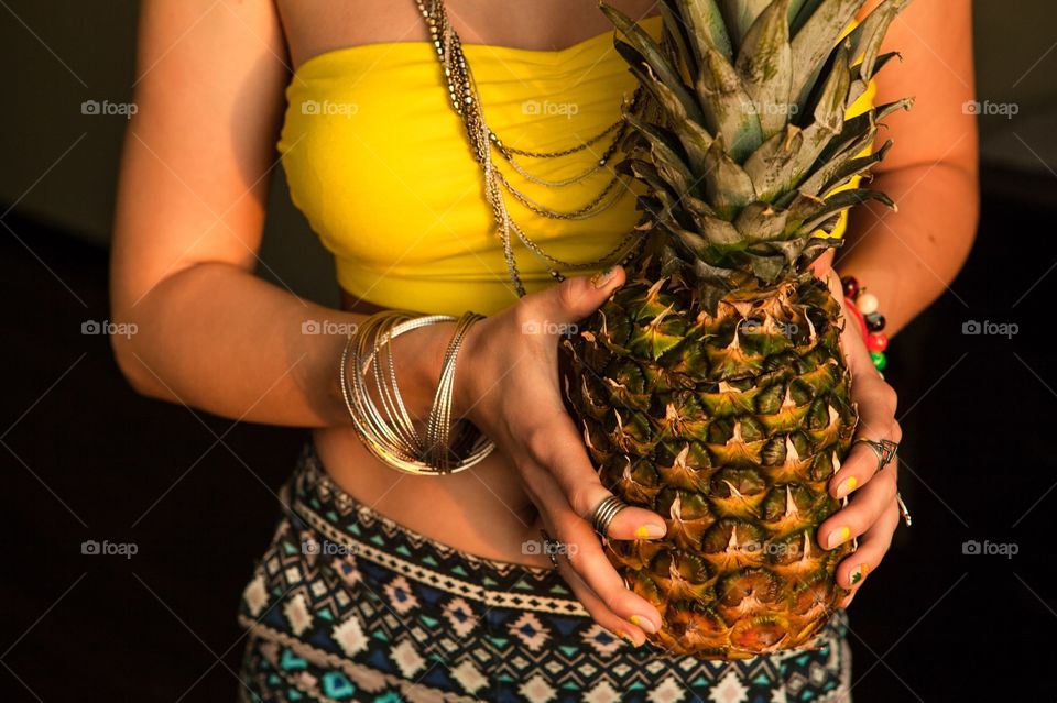 Woman with pineapple in hands