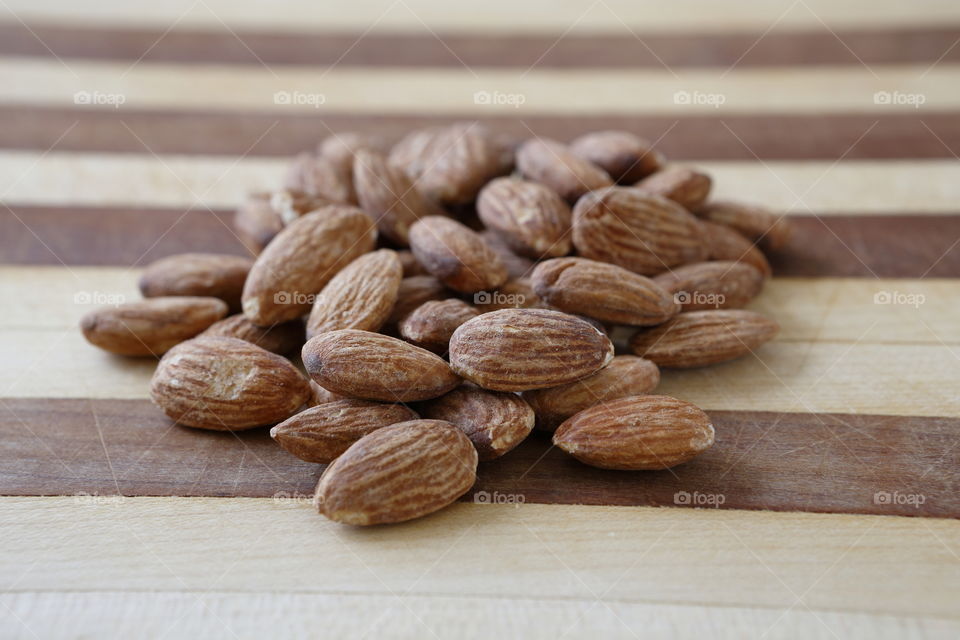 Almonds on cutting board. 