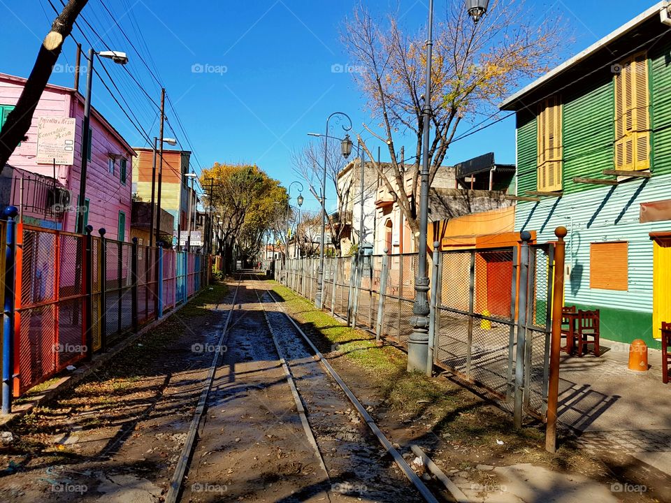 train railway betwen houses in la boca, buenos aires, argentina