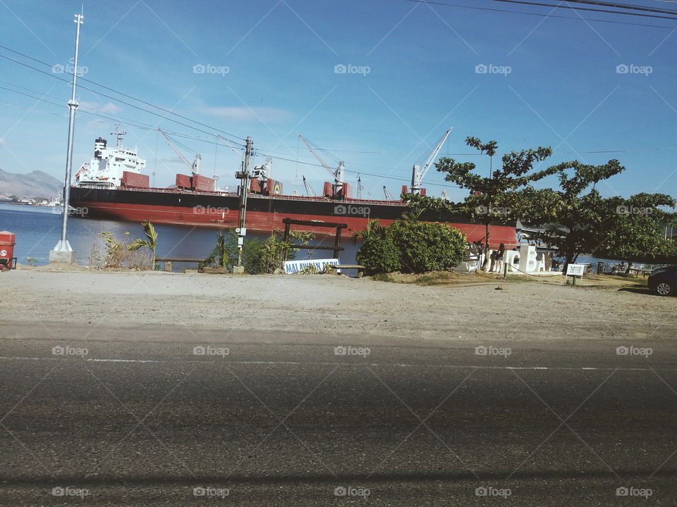 I took this photo while the car was cruising through Subic Bay. This ship is not moving.