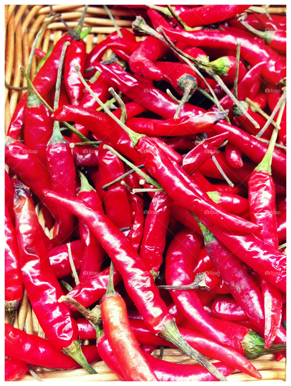 Fresh Red Chillies in wicker basket.