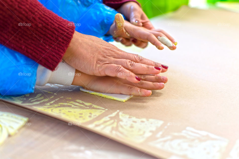 Mother teaches child engraving art at home