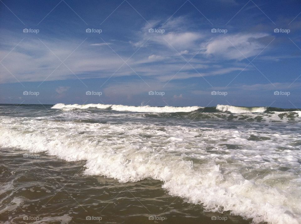 Strong waves. Large waves rolling into shore