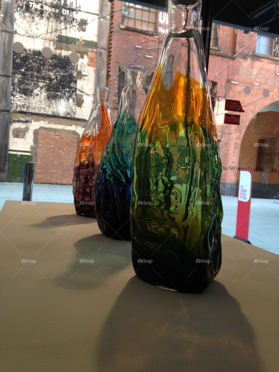 Glass. Glass bottles at Oxo gallery exhibition. London design festival
