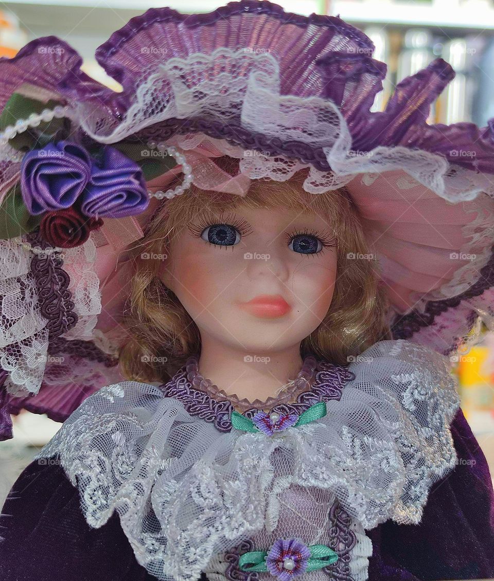 Doll with a purple hat.  All shades of purple