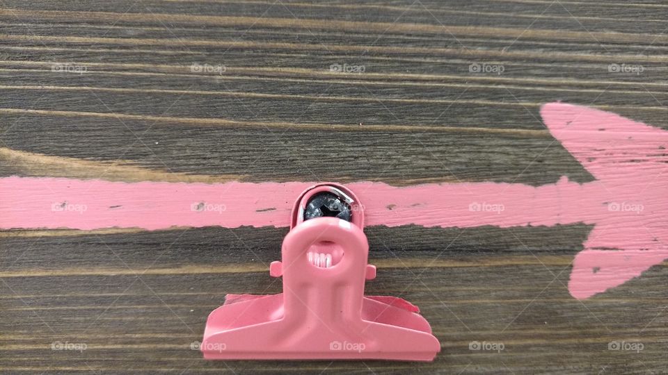 Pink clip on wooden table