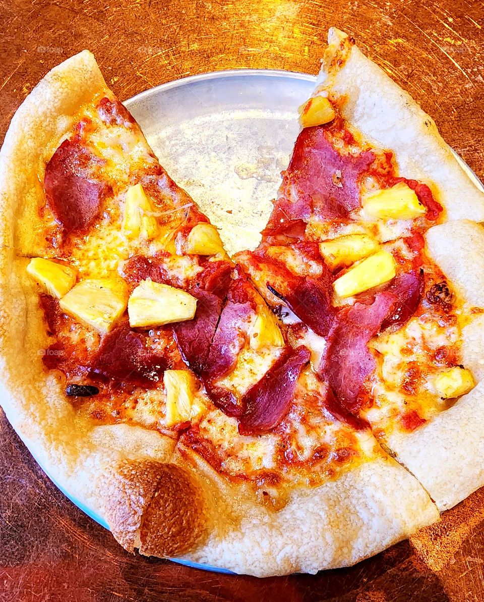 A triangular slice of this mouth-watering Hawaiian pizza featured grilled ham and pineapple and satisfied this hungry man's appetite