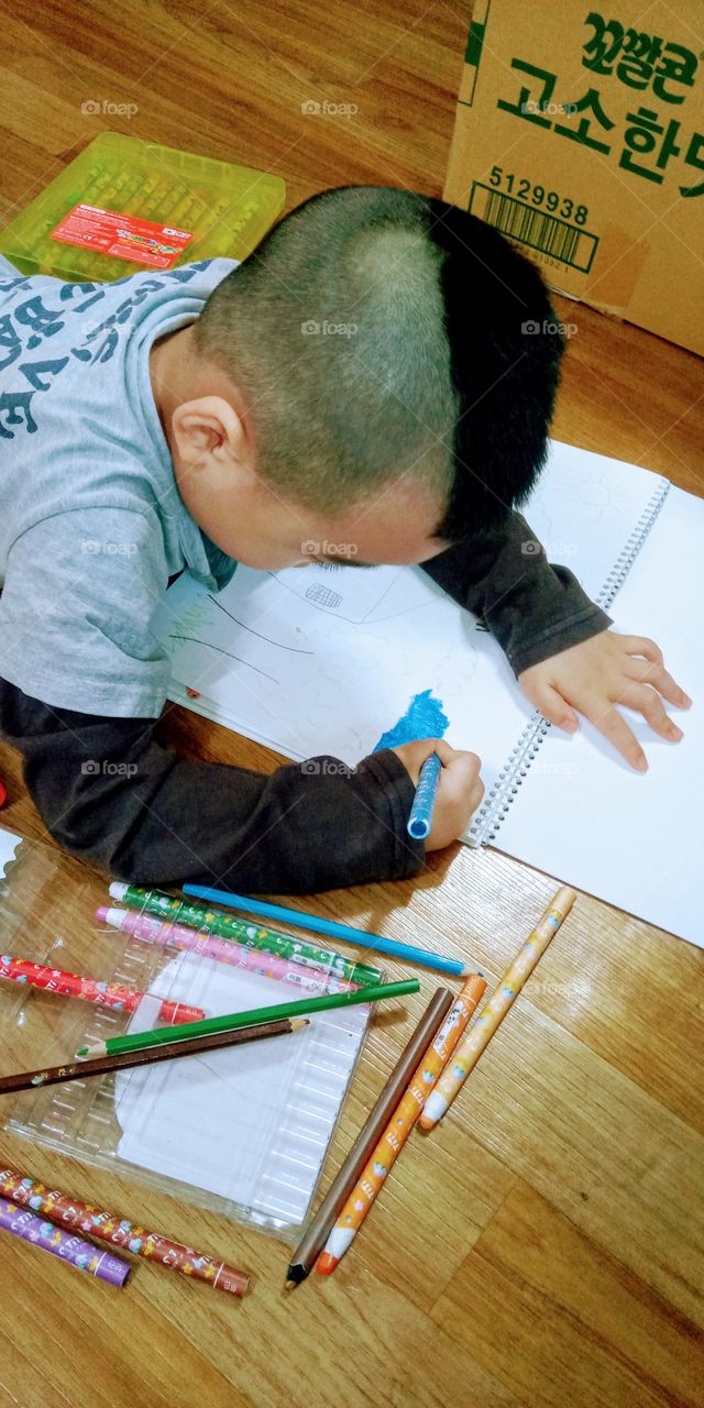 this kid draw a clouds and color it. its colour blue because he wants to have a sunny  weather with a blue sky.