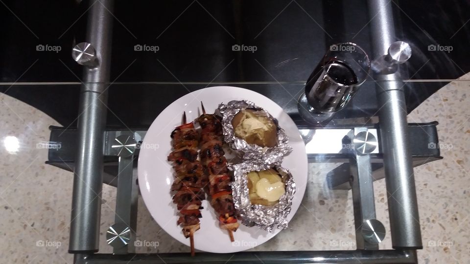 skewer and baked potatoes with sour cream and merlot