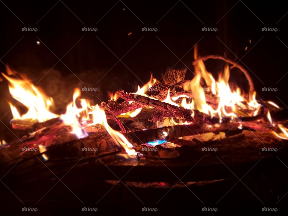 burning wood in a fire pit at night