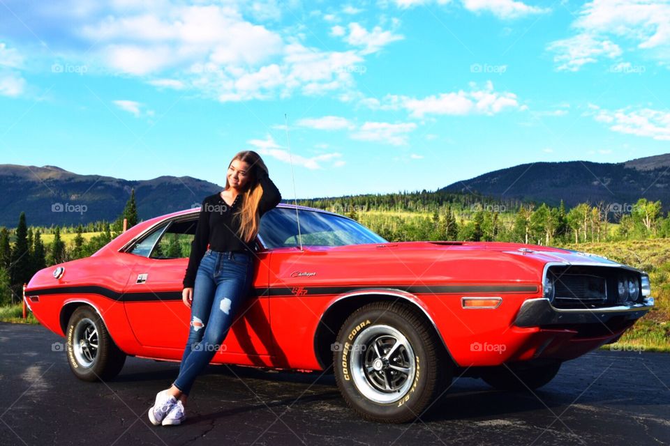 Young woman in front of a 1970 Dodge Challenger 