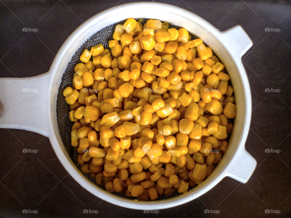 Corn kernels in a strainer