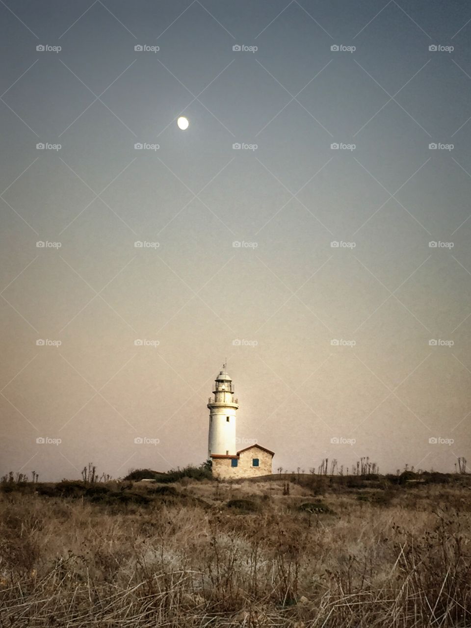 Two sources of light. Moon above a lighthouse! 
