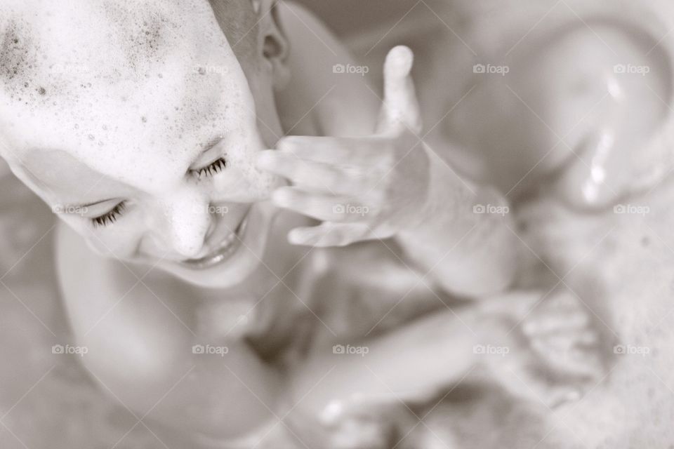 High angle view of cute girl taking bath