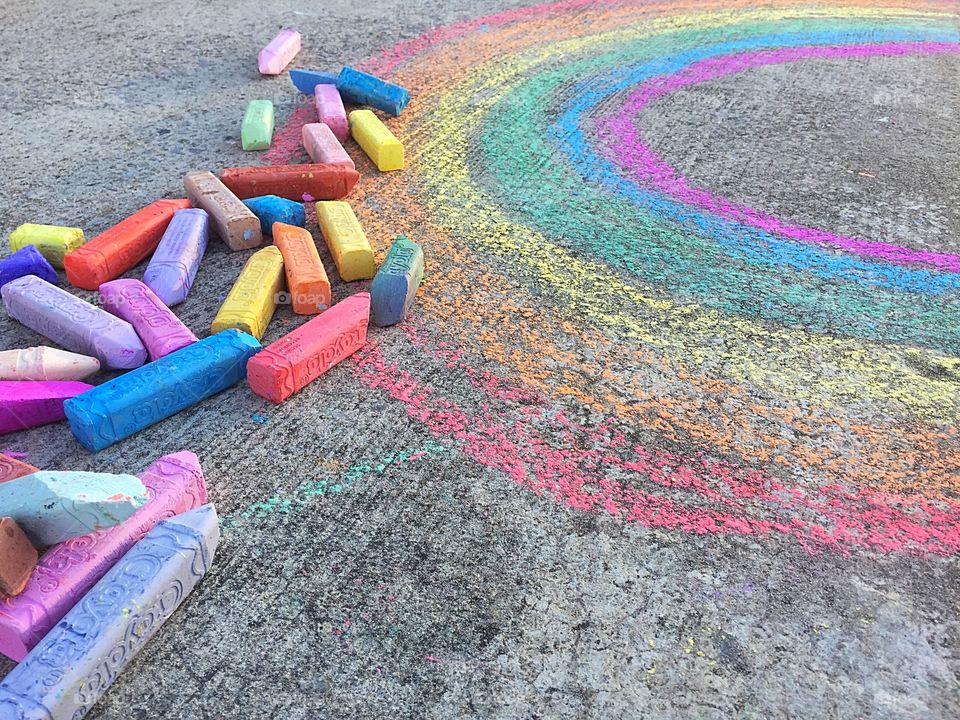 Chalk drawing of rainbow on sidewalk