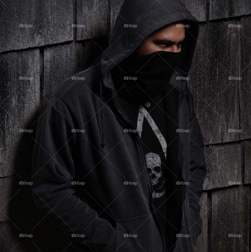 Man leaning against wall. dark, urban, assassin.