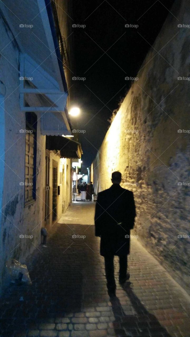 A man walk in a dark  street at essaouira City in Morocco