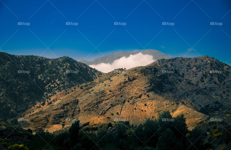 Cloud behind a mountain