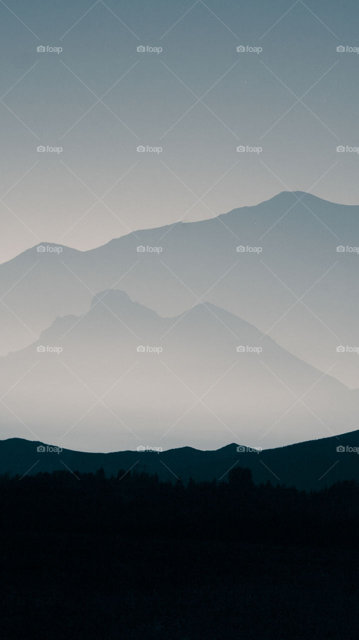 An inspiring mountain landscape. Tatry mountains in Slovakia. A beautiful wallpaper for smartphone screen. Monochrome blue abstract gradient with perspective.