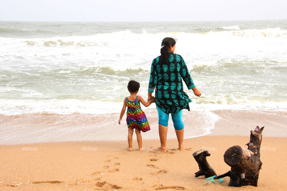 Mother and daughter in the beach, seashore, holiday