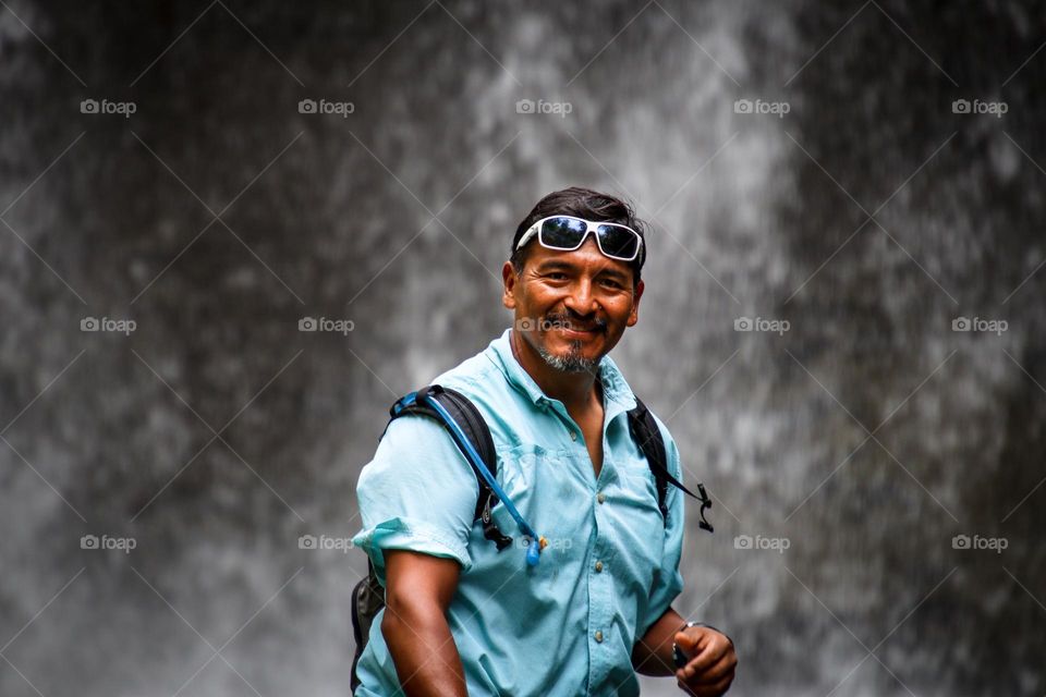 Happy middle-aged man in a blue shirt