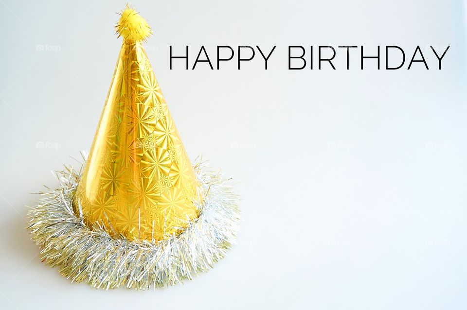 Happy birthday with party hat on gray background 