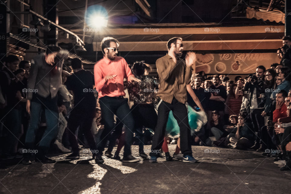 Street Dancing In The Night With Crowd Of People Watching
