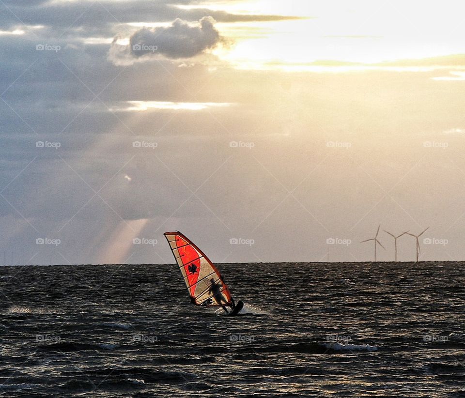 Windsurfer infront of windmill