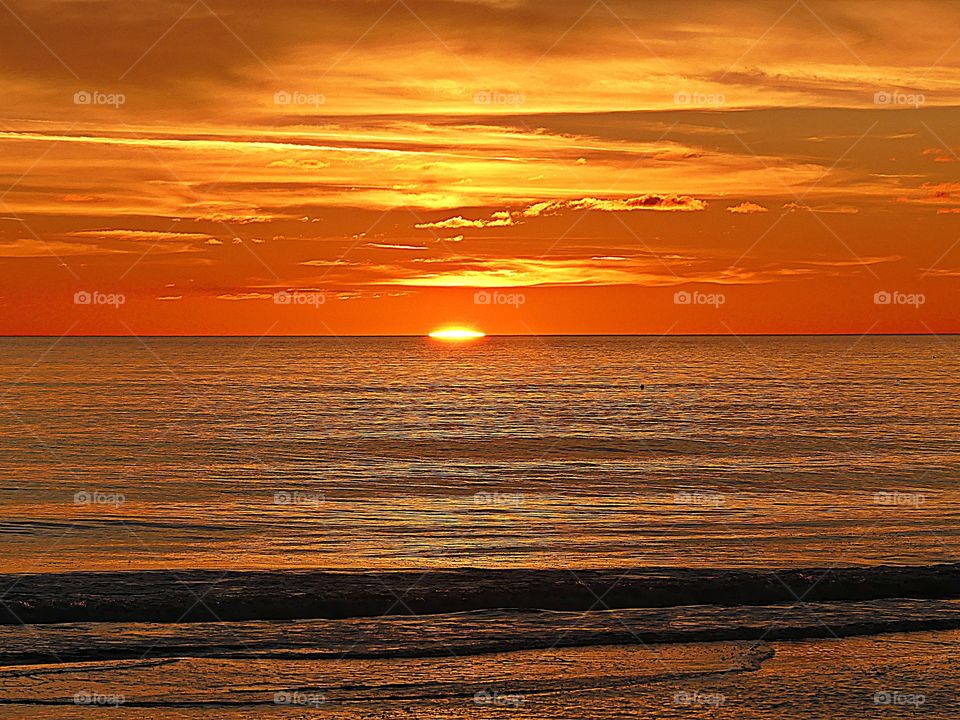 Descending SUNSET - A sunset is a perfect conclusion of the day. It's the silky, smooth collusion of skyburst reds, oranges and yellows into the calm of night.