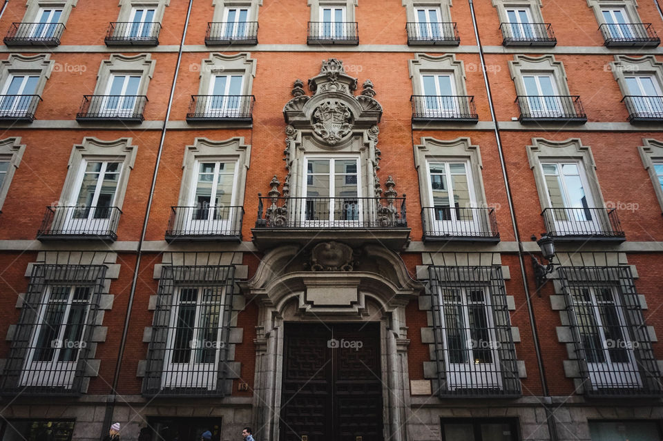 Beautiful brick building facade with many windows in Madrid, Spain 