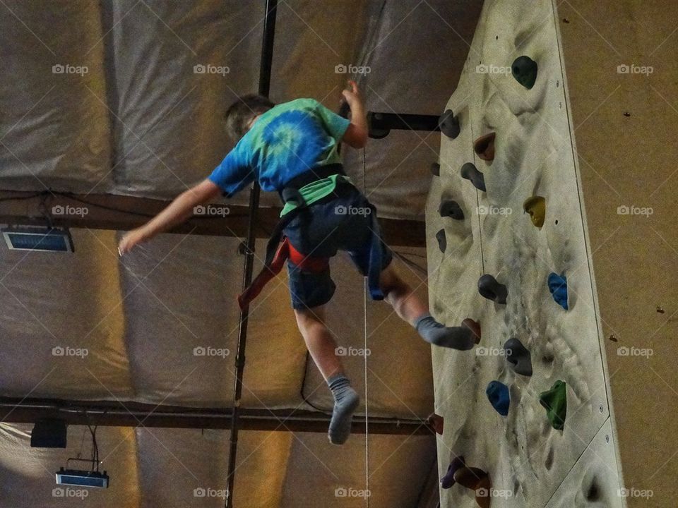 Rappelling Down A Rock Wall