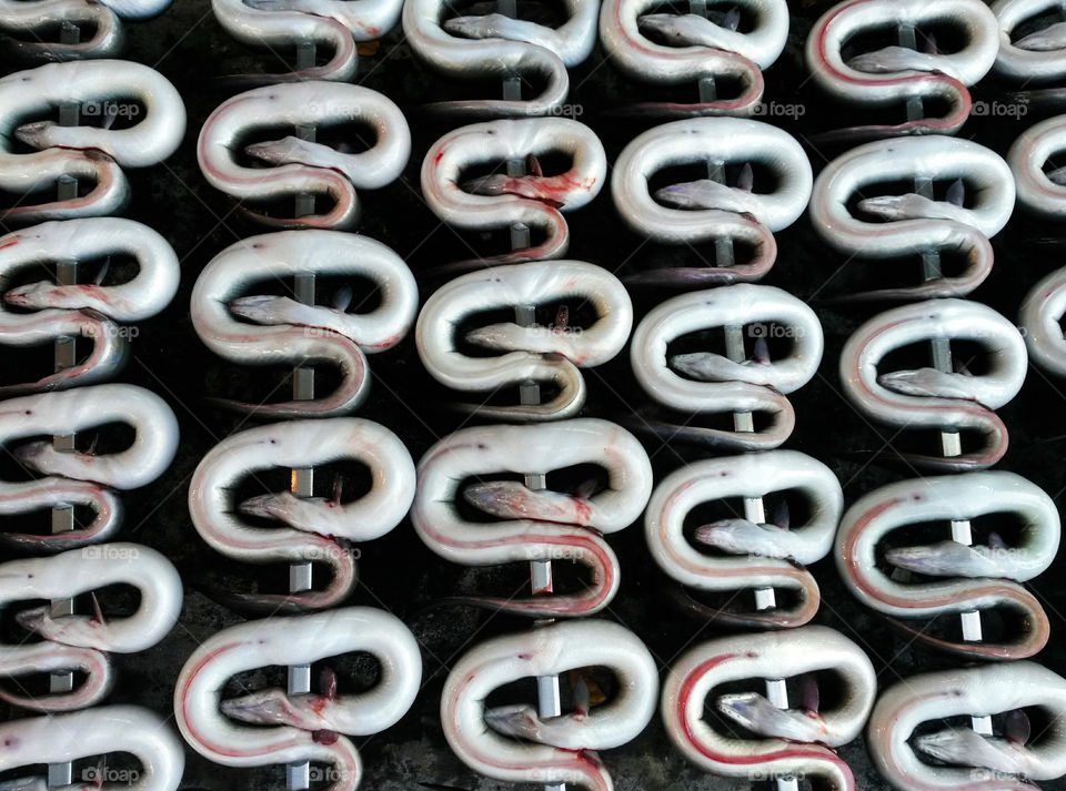 High angle view of eels preparing on barbecue