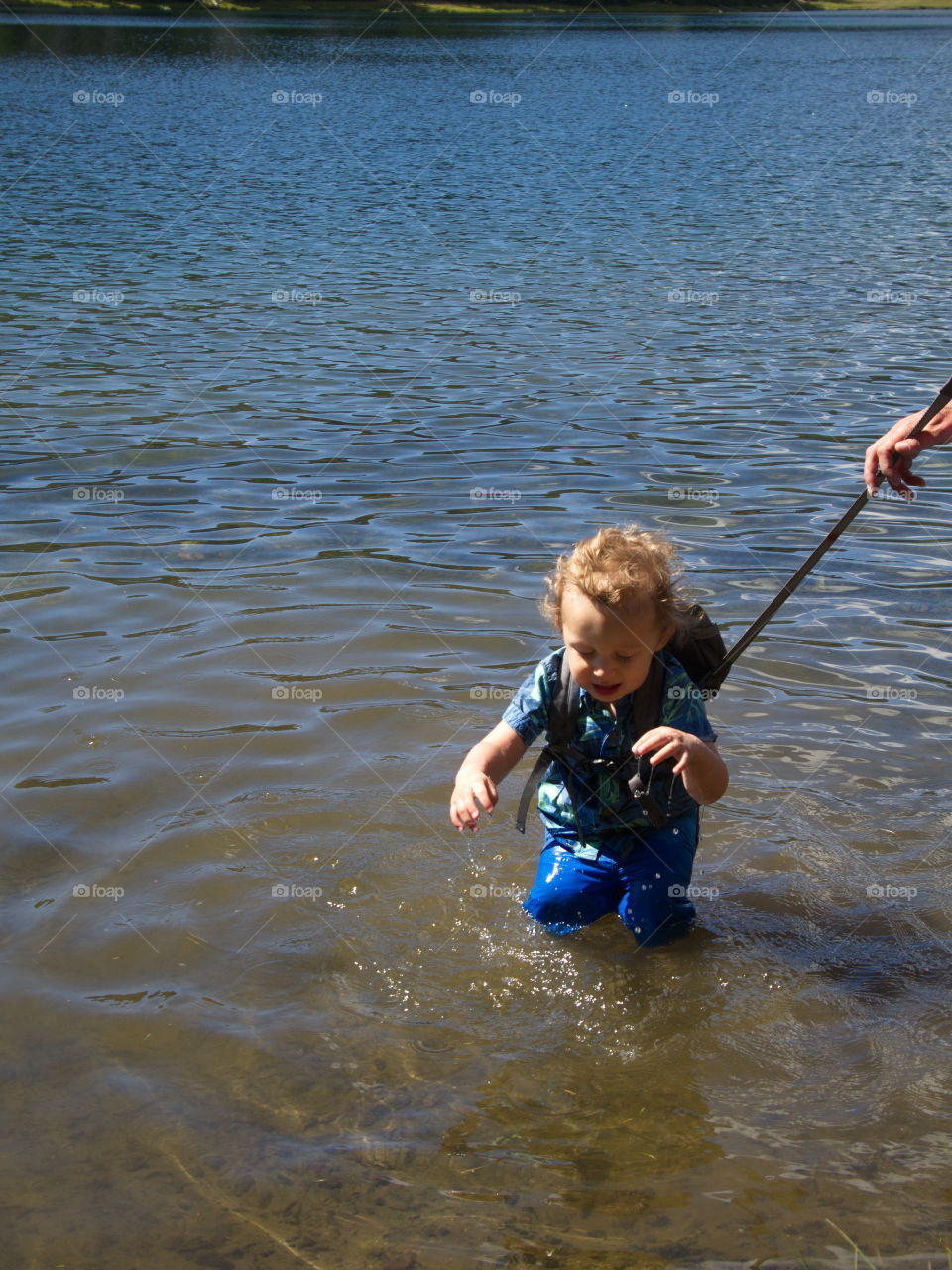 Little boy on summer vacation at high lake in Oregon forest 