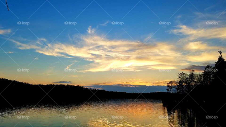 twilight on lake with blue skies.