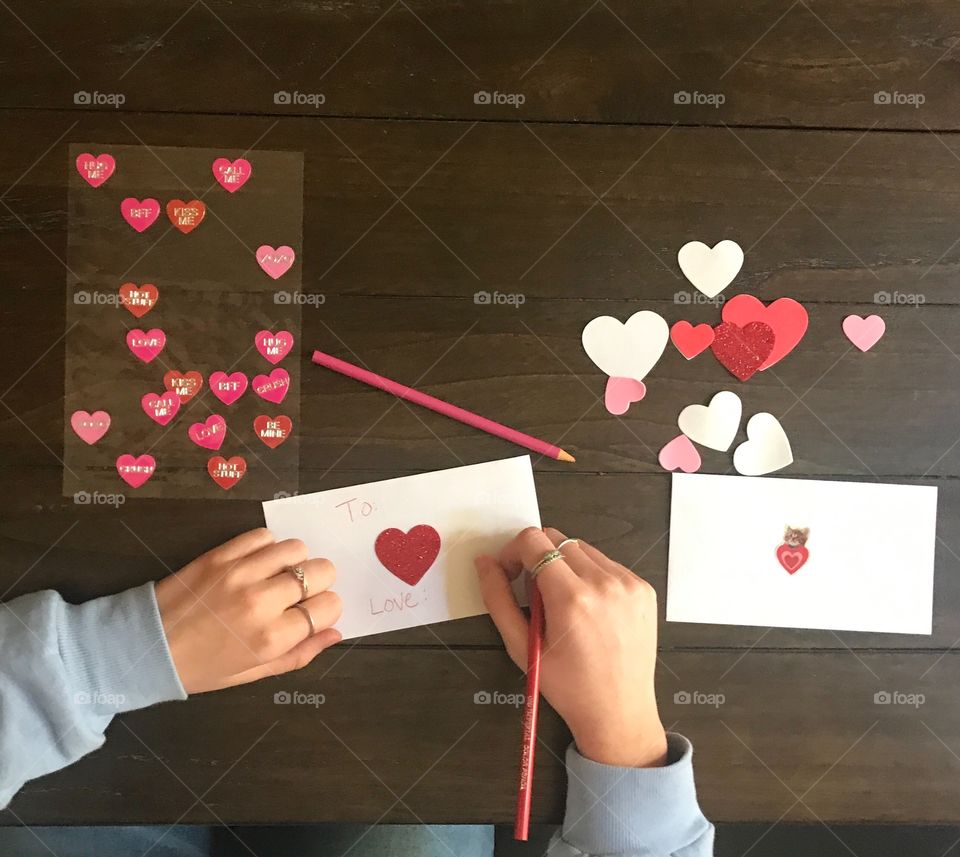 Writing valentines letters and cards to family and friends in celebration of Valentine’s Day. USA, America 