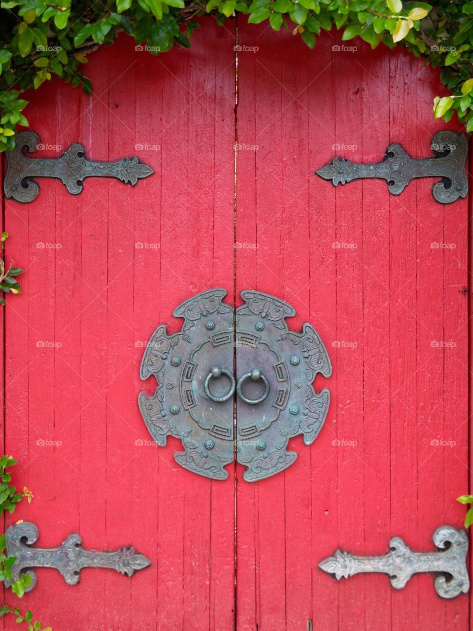 Old red door, Hawaii. Red door with Asian traditional ironwork, Honolulu,Hawaii.

