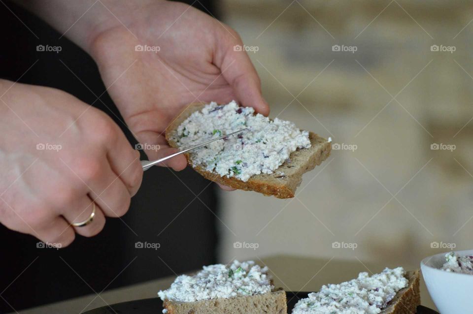 Healthy breakfast- white cottage cheese with onions, chives, salt and pepper on bread