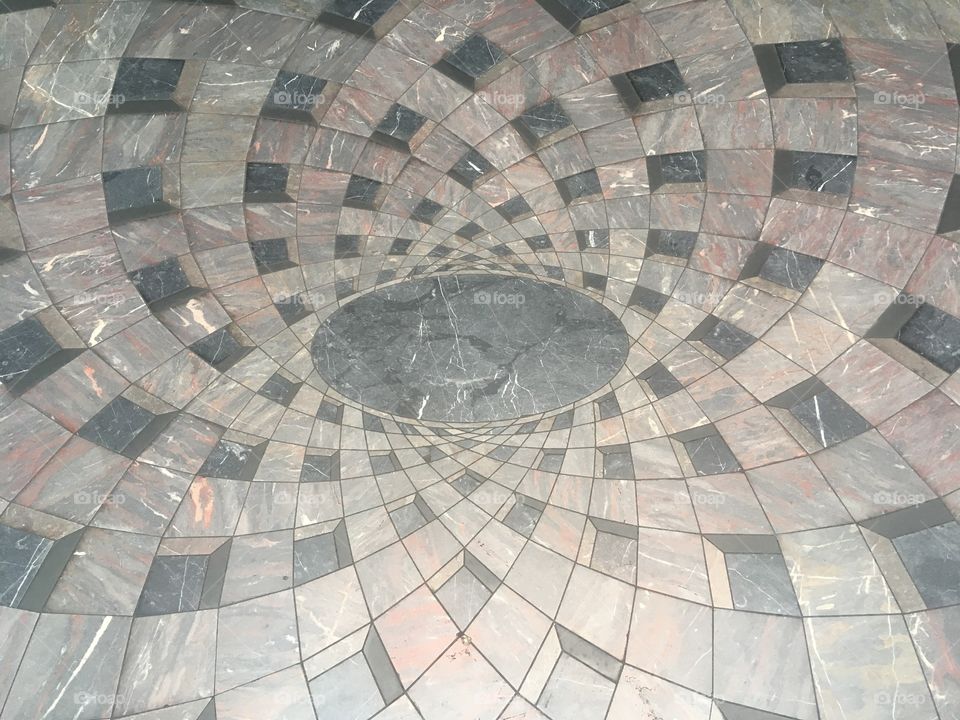 Symmetrical floor pattern inside the Burlington Arcade off of Piccadilly in London. Visited in Summer.