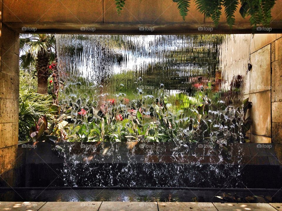 Falling in the garden. Waterfall in an outdoor garden exhibit