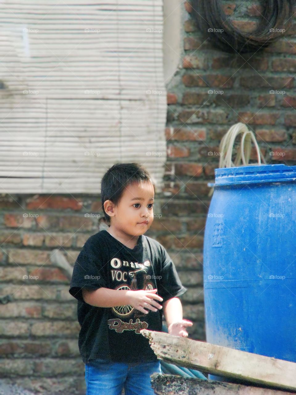 Semarang, Central Java, Indonesia - December 12, 2023: young boy in black dress and a shirt