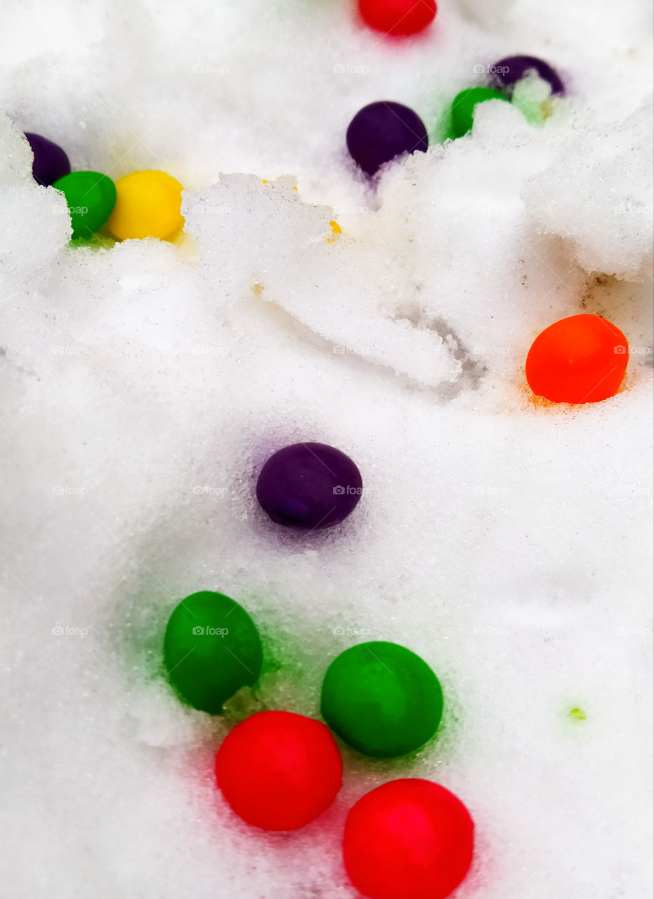 Multicolored candies in the snow