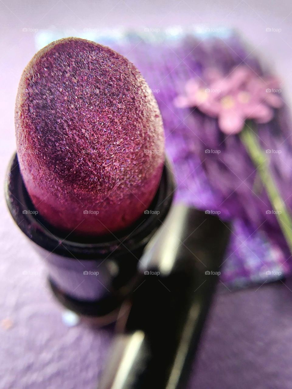 Shimmering purple lipstick.