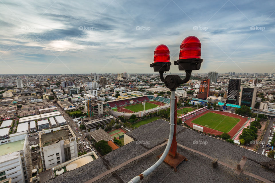 Twin red obstruction light on the rooftop with city view 