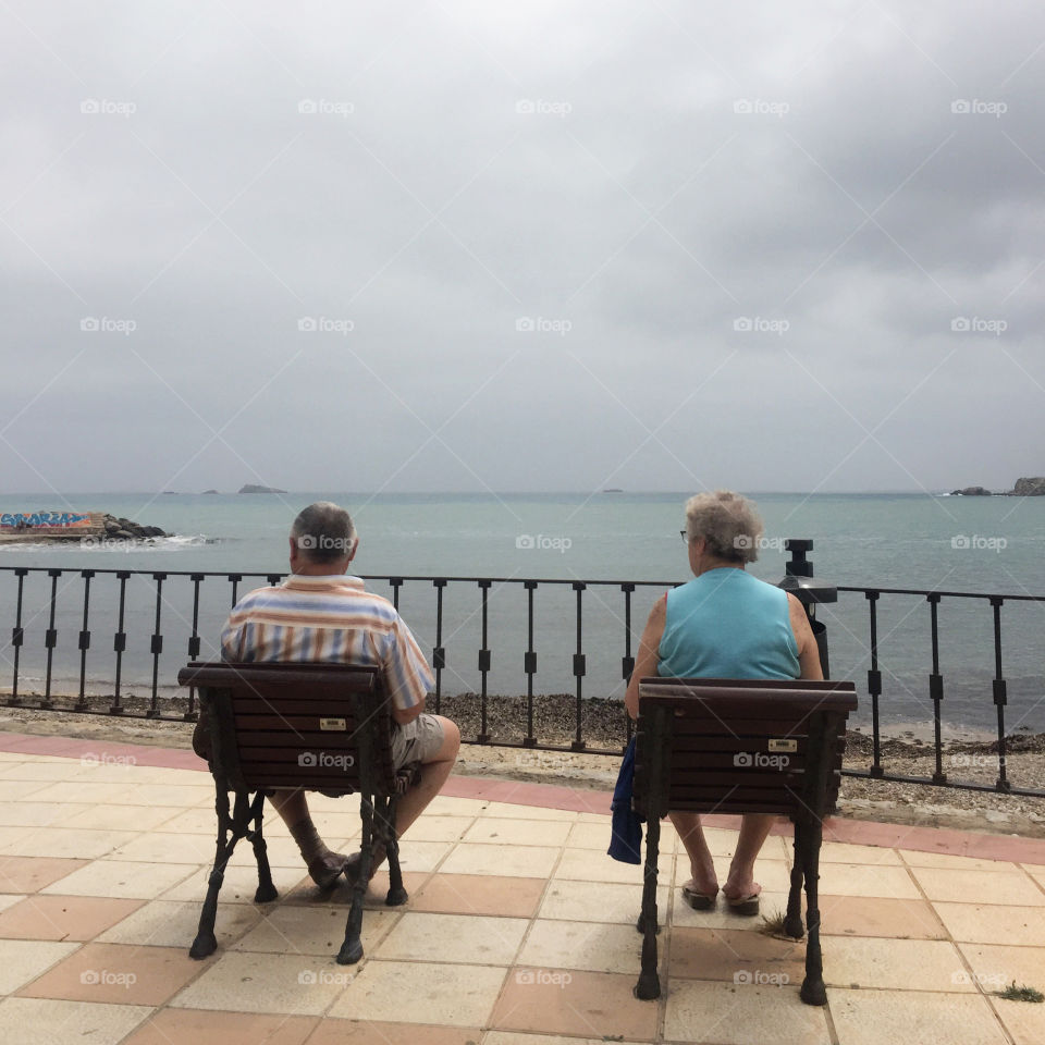 Elder couple sitting and enjoying the view 