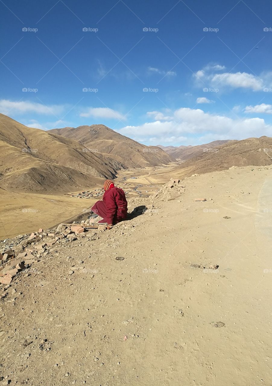 Nun staring into the Valley at Se Da Buddhist Monastery and School in Sichuan Province, China.

Se Da is currently the largest Tibetan Buddhist school in the world and not open to westerners.