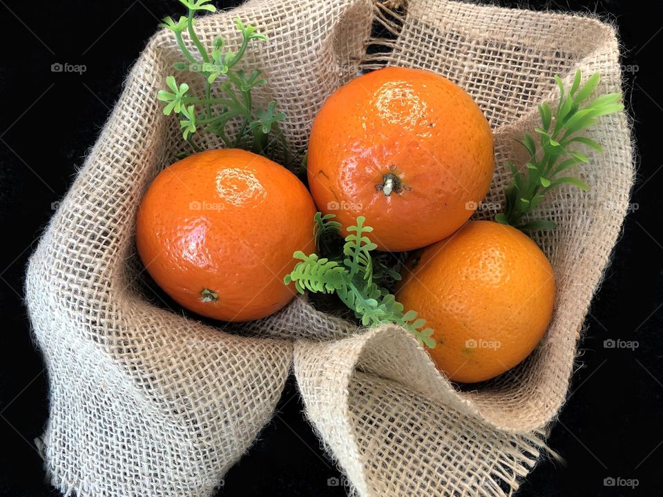 Basket of sweet tangerines with a bright orange color. 