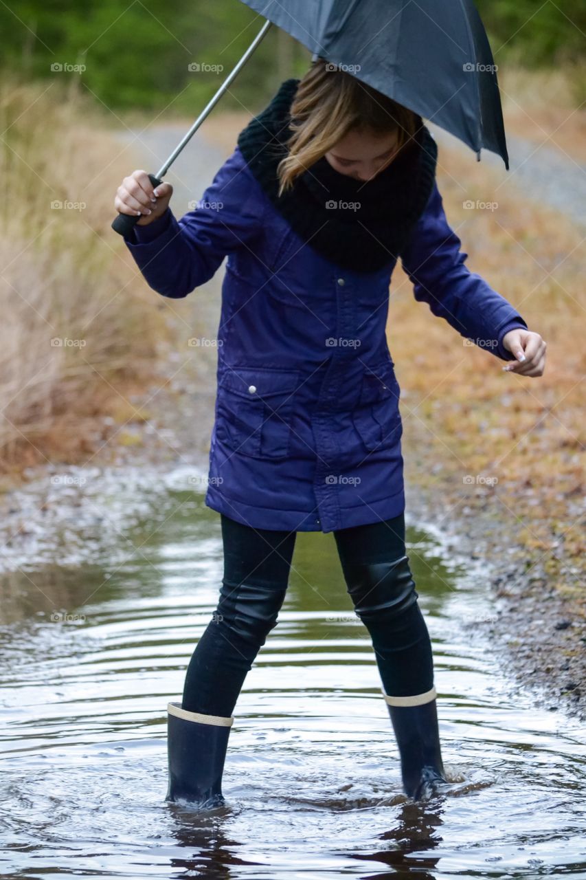 Young woman holding umbrella