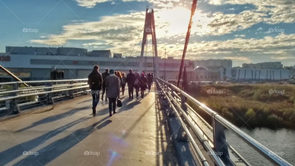 Those people are walking towards a metro station. 